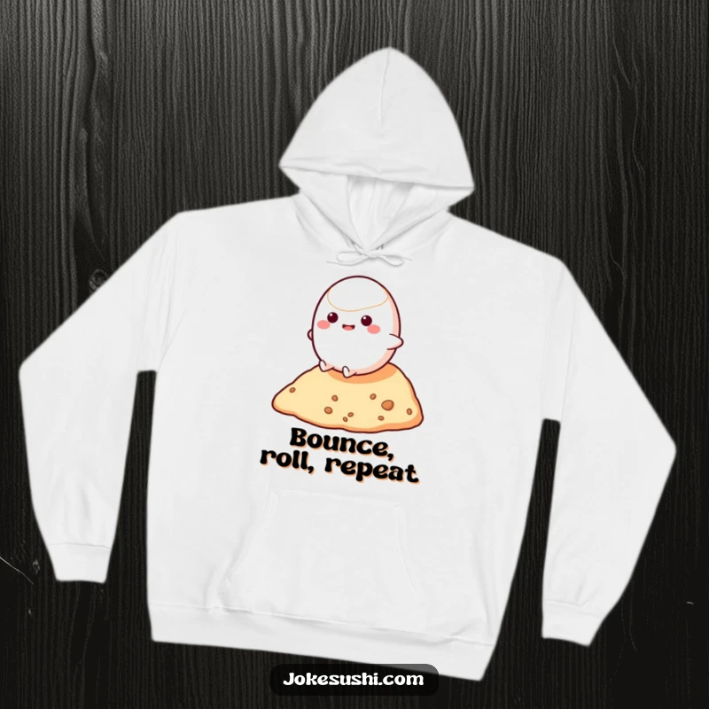 Funny hoodie illustrating a bouncy mochi character rolling downhill with abandon, offering cozy comfort and a dose of bouncy humor.