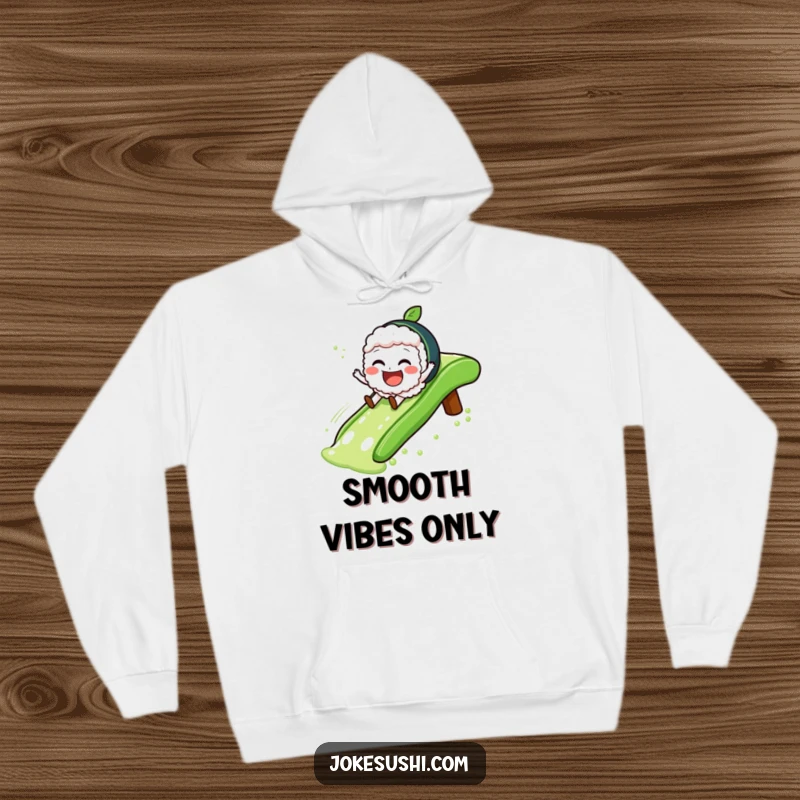 Funny Hoodie depicting a jovial sushi character gleefully sliding down a green tea slide, perfect for cozy fun.