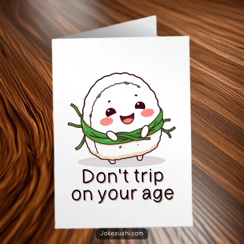 Funny Free Printable birthday card showing a smiling onigiri character comically tripping over its own seaweed belt, perfect for a chuckle.